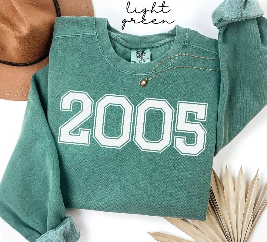 Light green sweatshirt with '2005' printed on it, displayed on a white background.