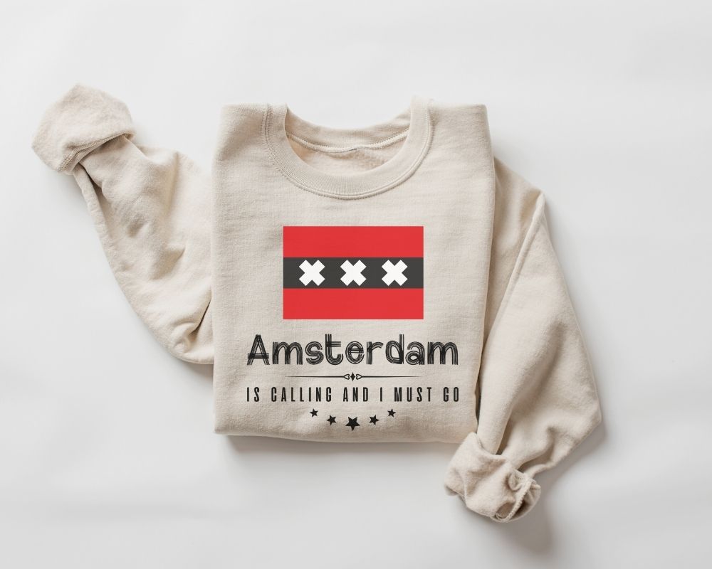 A beige (sand) sweatshirt featuring an Amsterdam graphic and text on a white background.