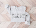 Gray (Ash) sweatshirt with 'Bake The World A Better Place' text on a wooden floor