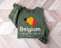 Military green sweatshirt with Belgium map design on a wooden floor