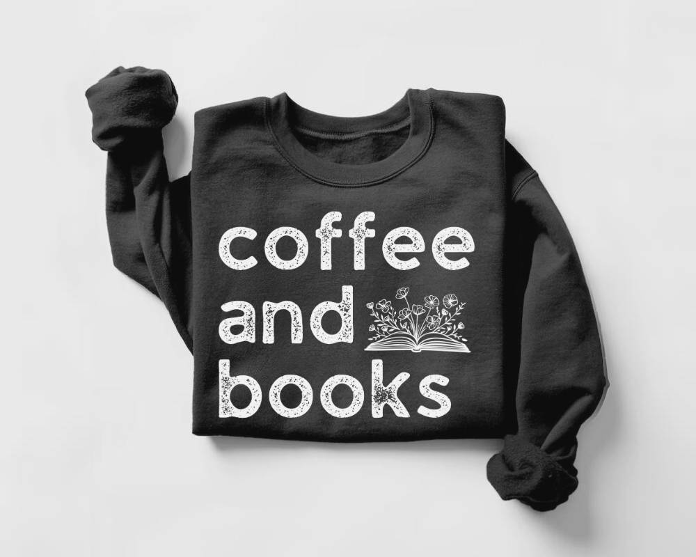 Black sweatshirt with 'coffee and books' text on a light gray background