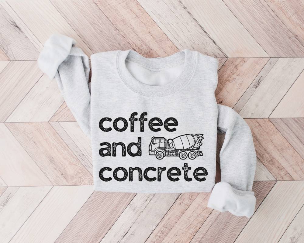 White (ash) sweatshirt with 'coffee and concrete' text and a mixer graphic on a wooden floor.