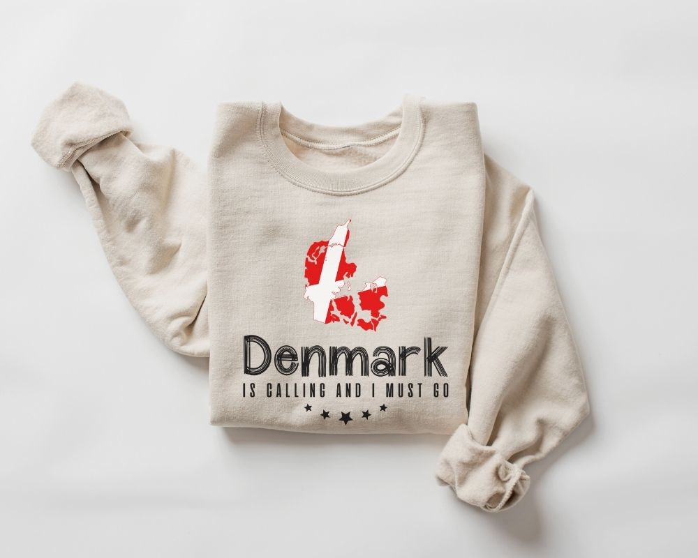 A beige (sand) sweatshirt featuring a Danish flag design along with text, all displayed on a white background.