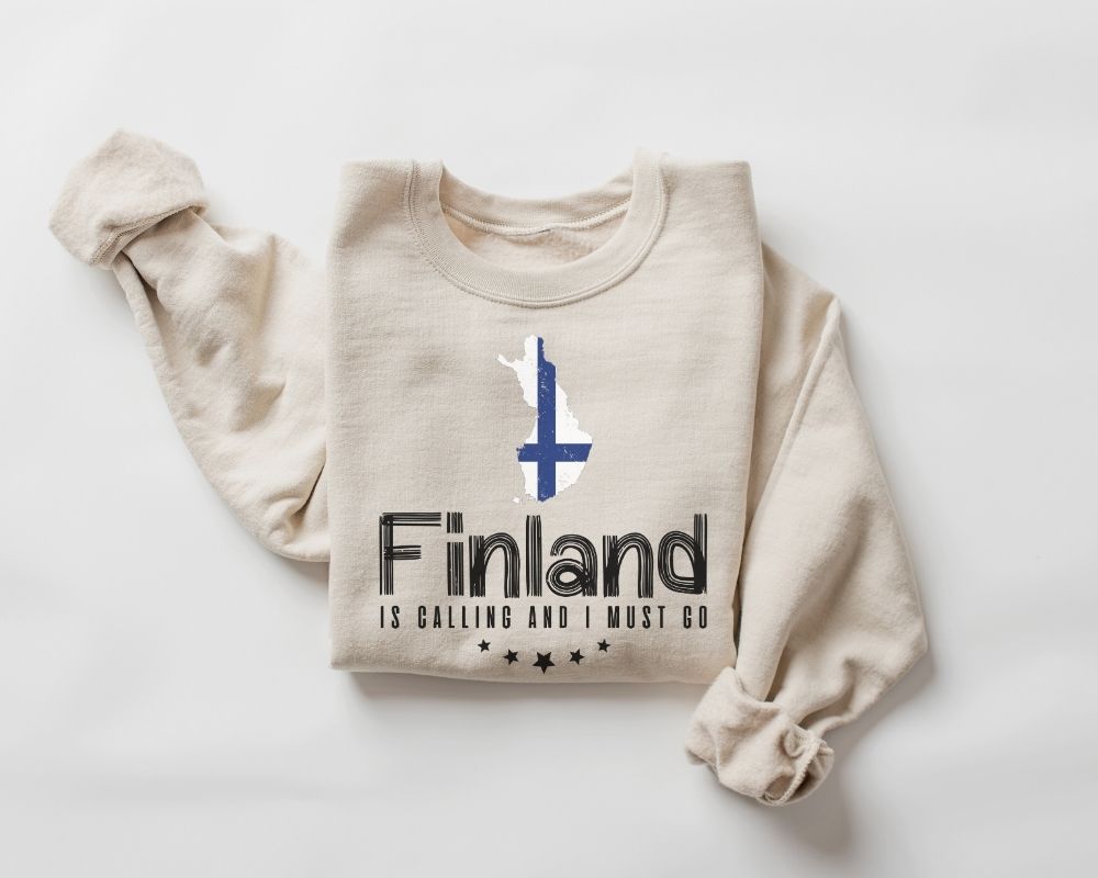 Beige (sand) sweatshirt with 'Finland is Calling and I Must Go' text and graphic on a white background