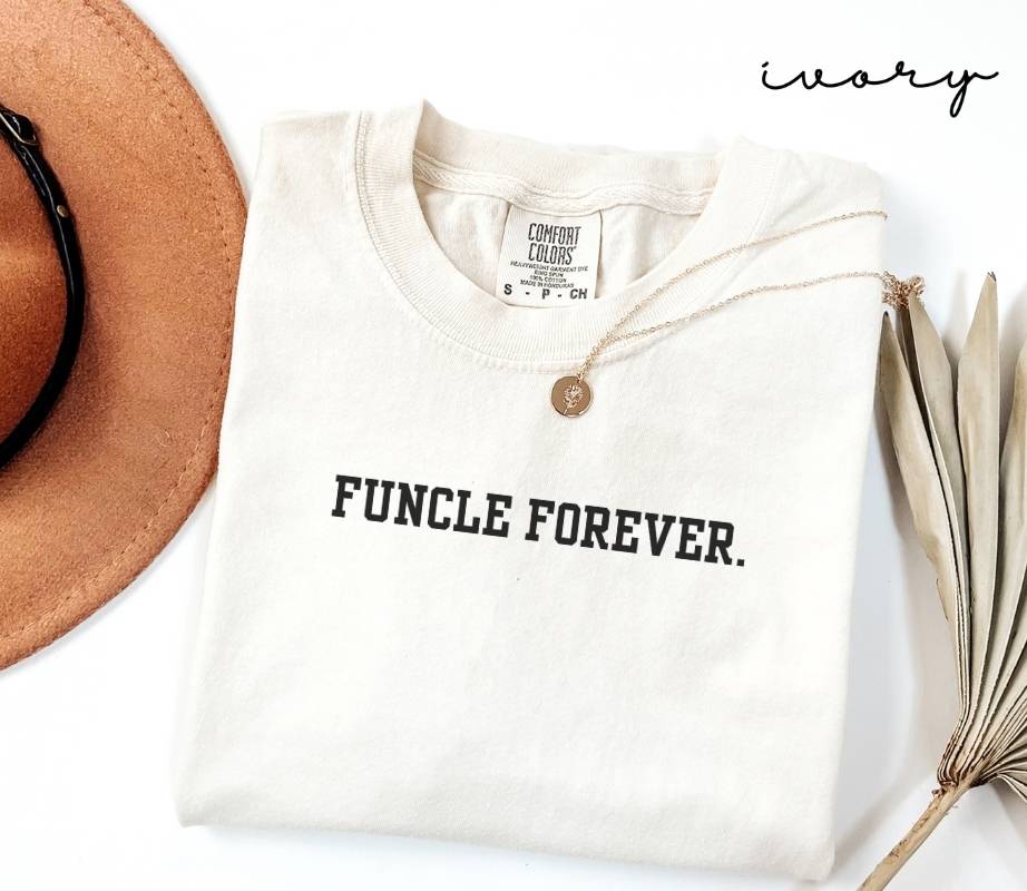 White T-shirt with the text 'FUNCLE FOREVER,' a brown hat, and a dried plant on a white background.