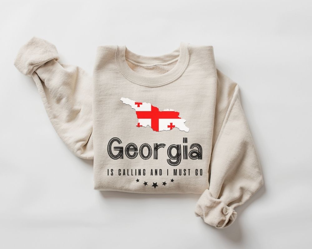 Beige (sand) sweatshirt with 'Georgia' text and flag design on a white background