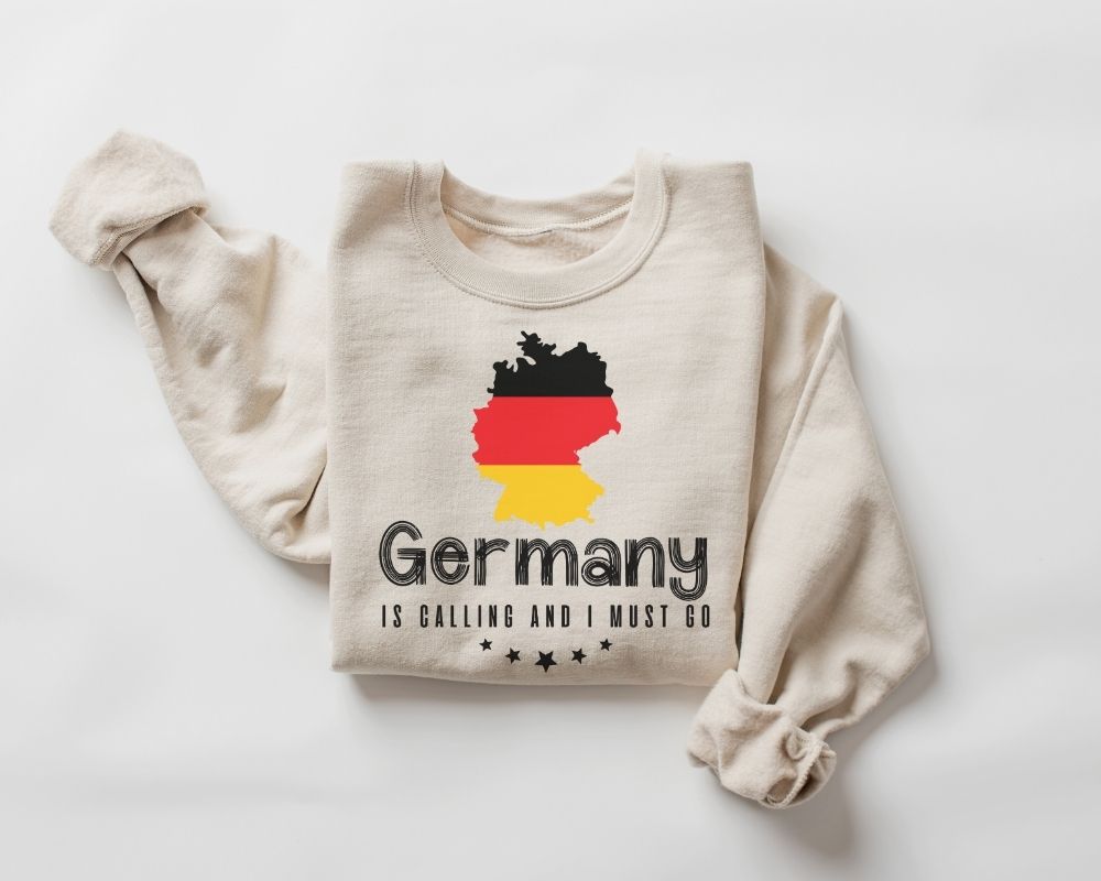 A beige (sand) sweatshirt featuring a design of the German flag along with text on a white background.