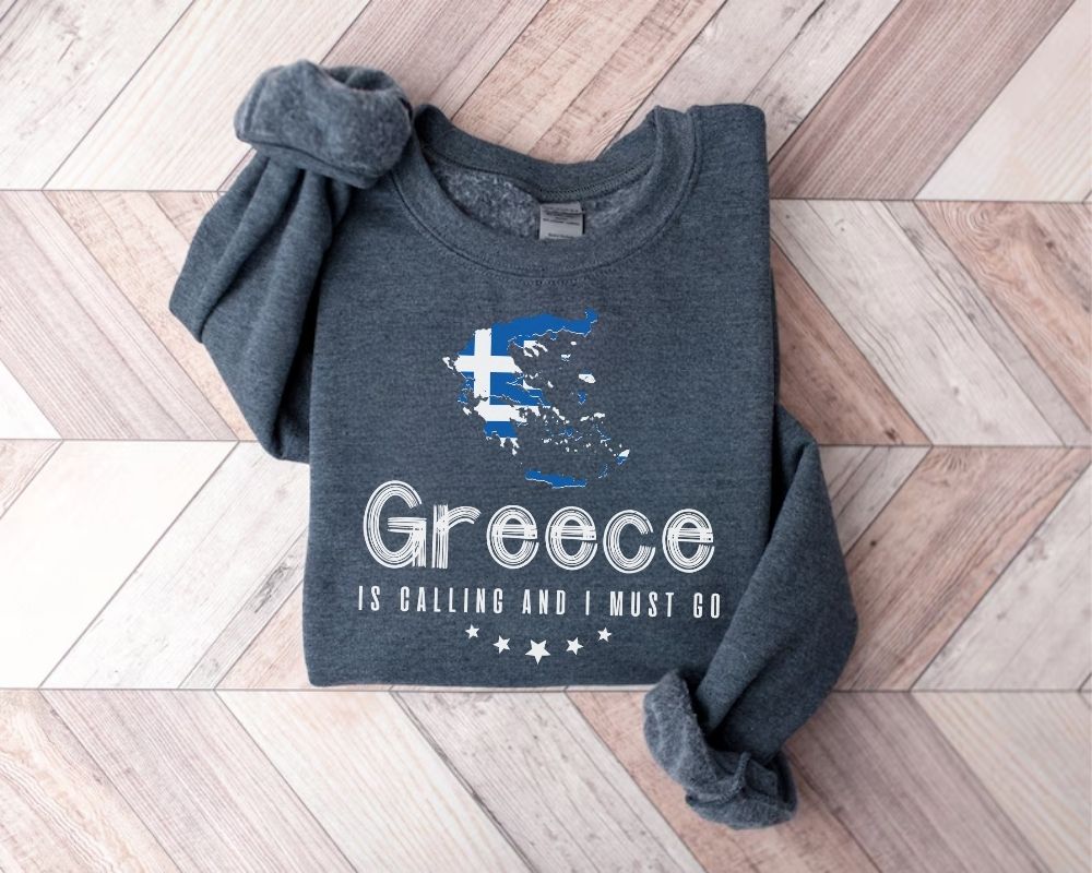 Dark gray (dark heather) sweatshirt with Greece map and text on a wooden floor