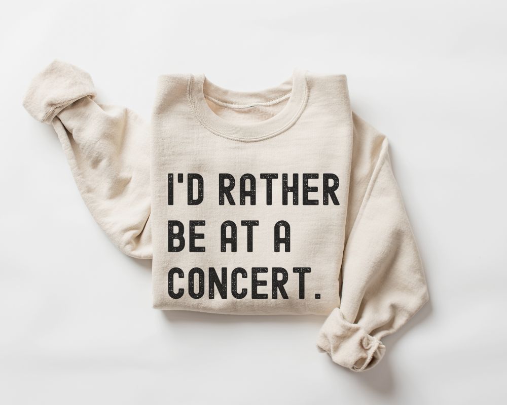 Beige (Sand) sweatshirt with text 'I'd Rather Be at a Concert' on a white background