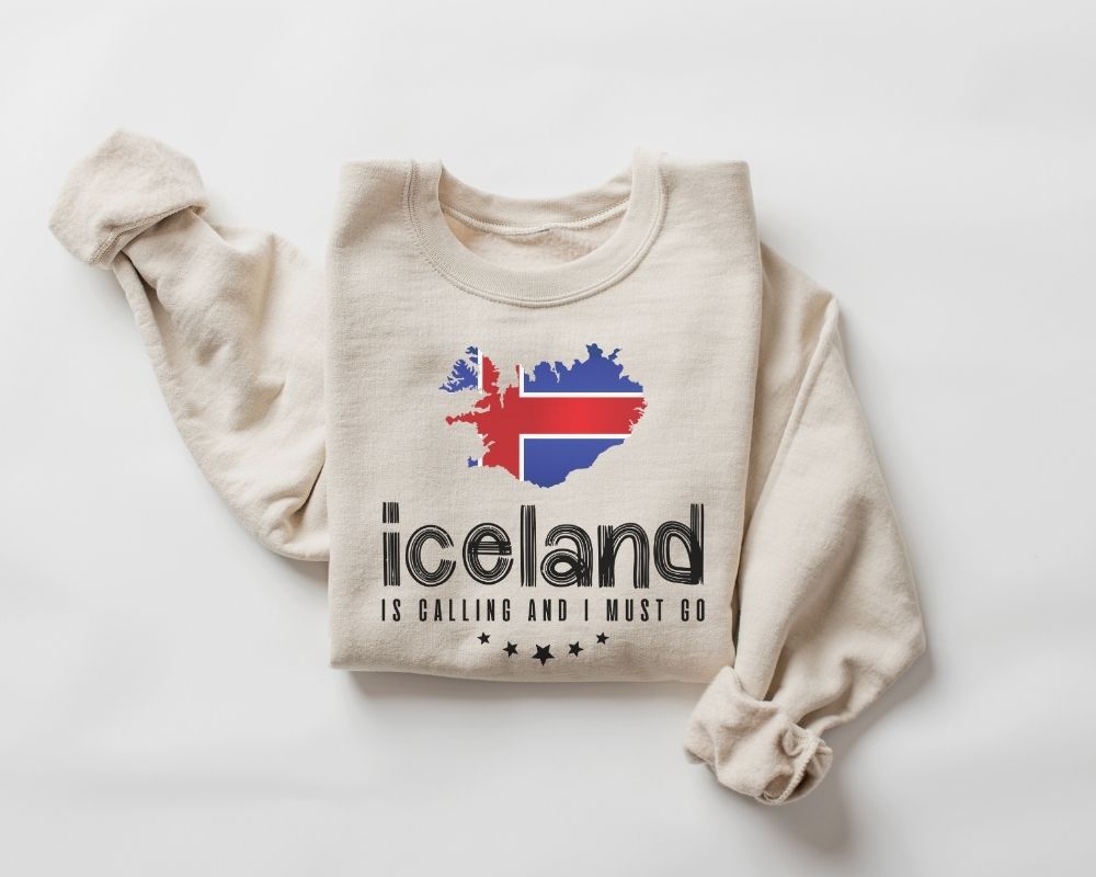 Beige (sand) sweatshirt with Icelandic design and text on a white background