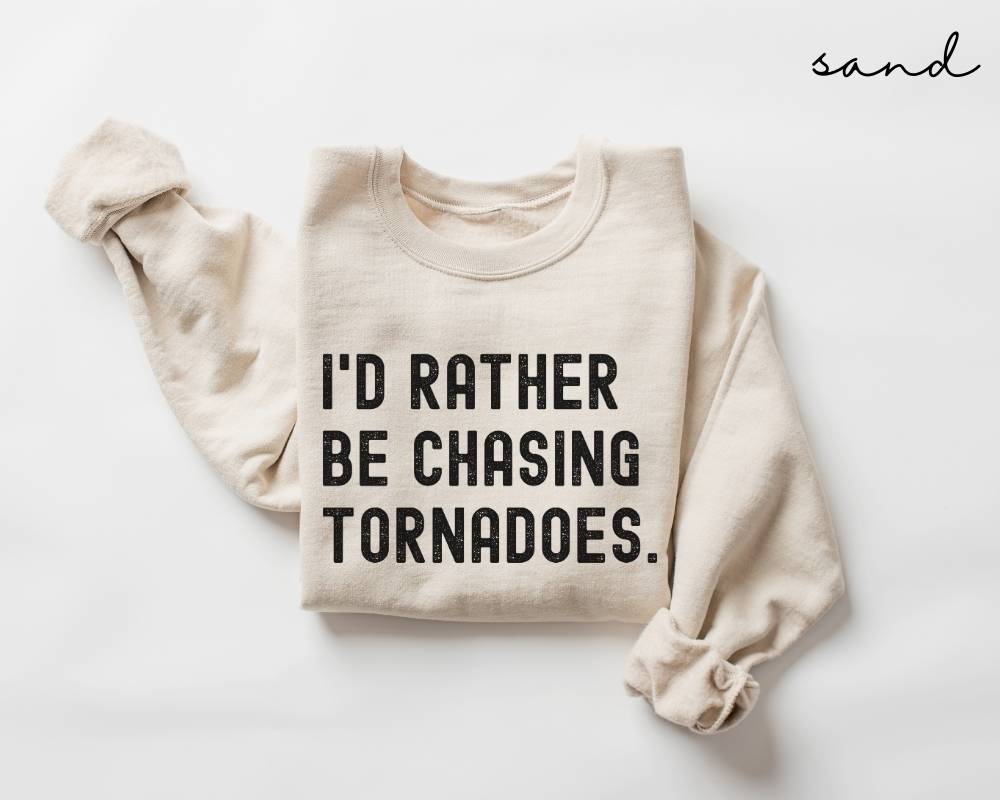 Beige (sand) sweatshirt with text 'I'd rather be chasing tornadoes' on a white background