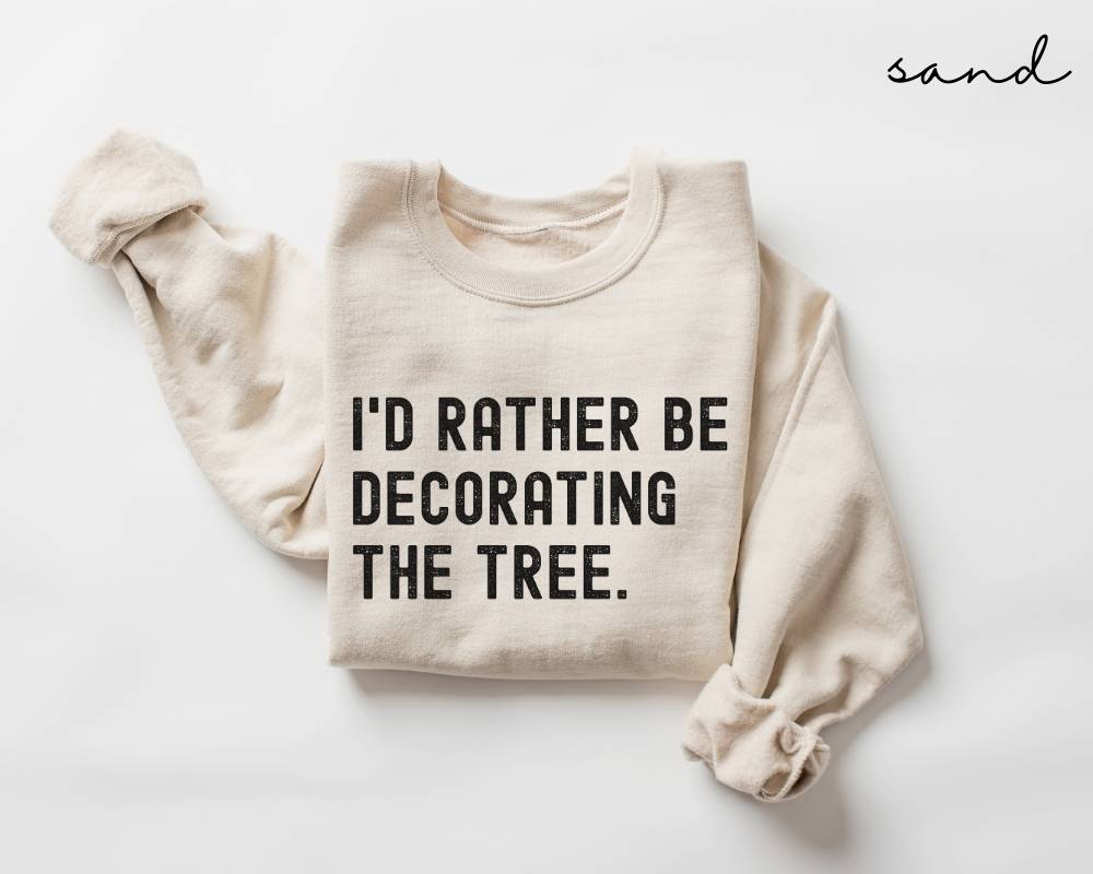 Beige (sand) sweatshirt with text 'I'd Rather Be Decorating The Tree' on a white background