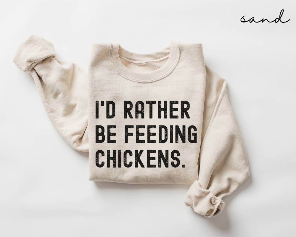 Beige (sand) sweatshirt with 'I'd Rather Be Feeding Chickens' text on a white background