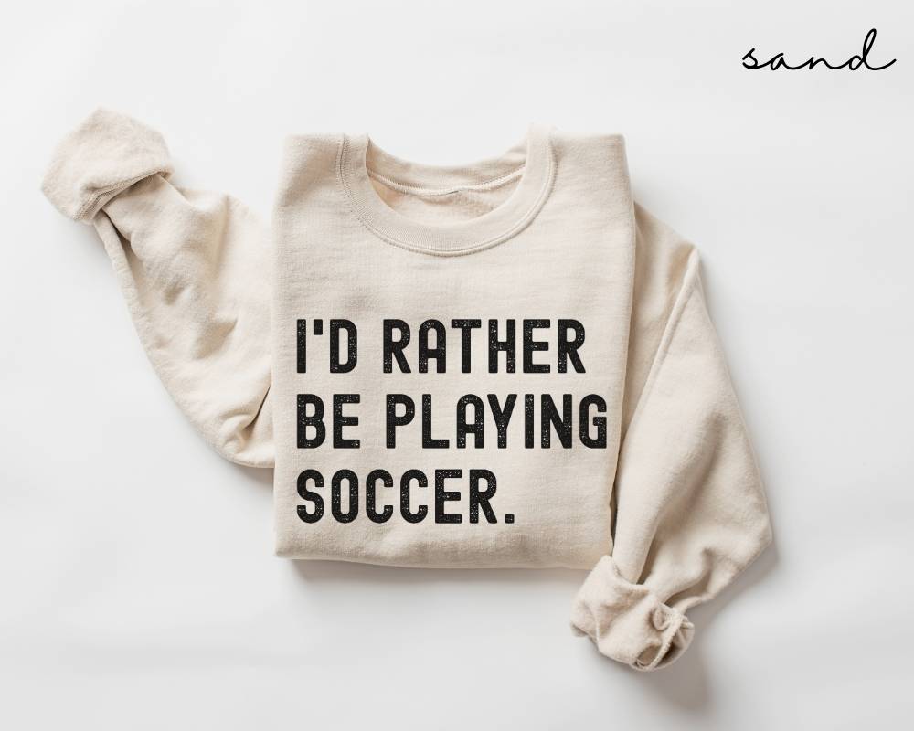 Beige (sand) sweatshirt with 'I'd Rather Be Playing Soccer' text on a white background