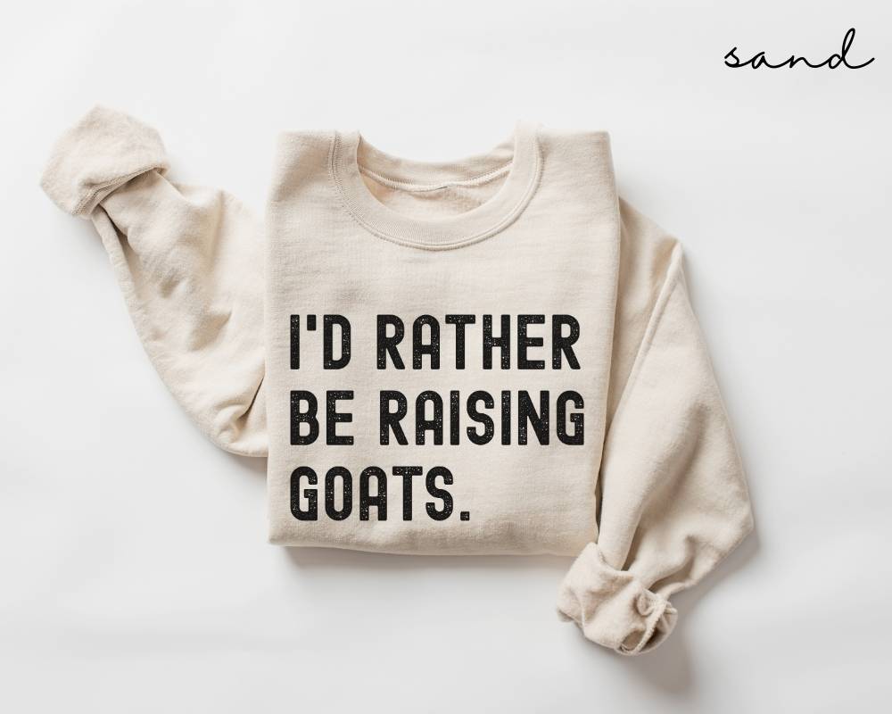 Beige (sand) sweatshirt with 'I'd Rather Be Raising Goats' text on a white background