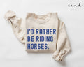 Beige (sand) sweatshirt with blue text 'I'd Rather Be Riding Horses' on a white background