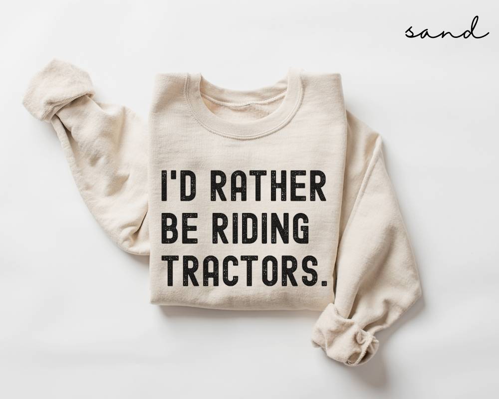 Beige (sand) sweatshirt with 'I'd rather be riding tractors.' text on a white background