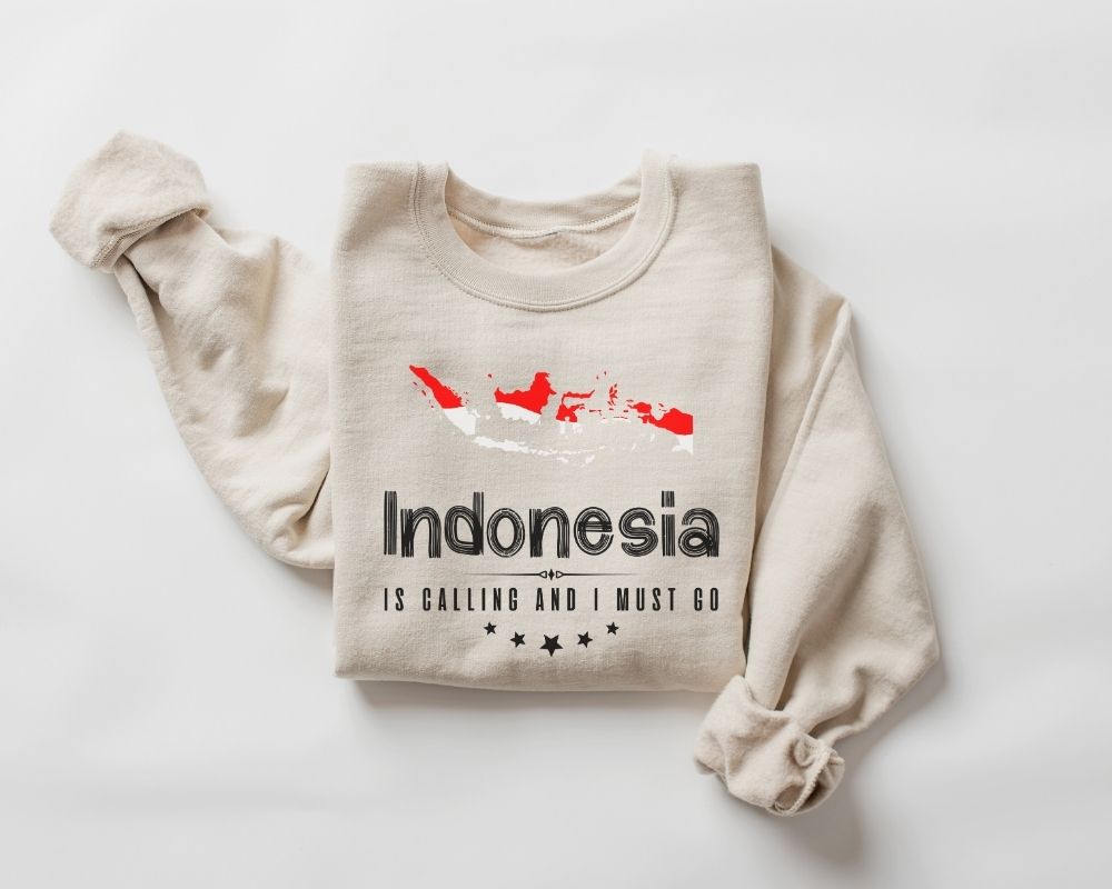 Beige (sand) sweatshirt with 'Indonesia is calling and I must go' text and map design on a white background