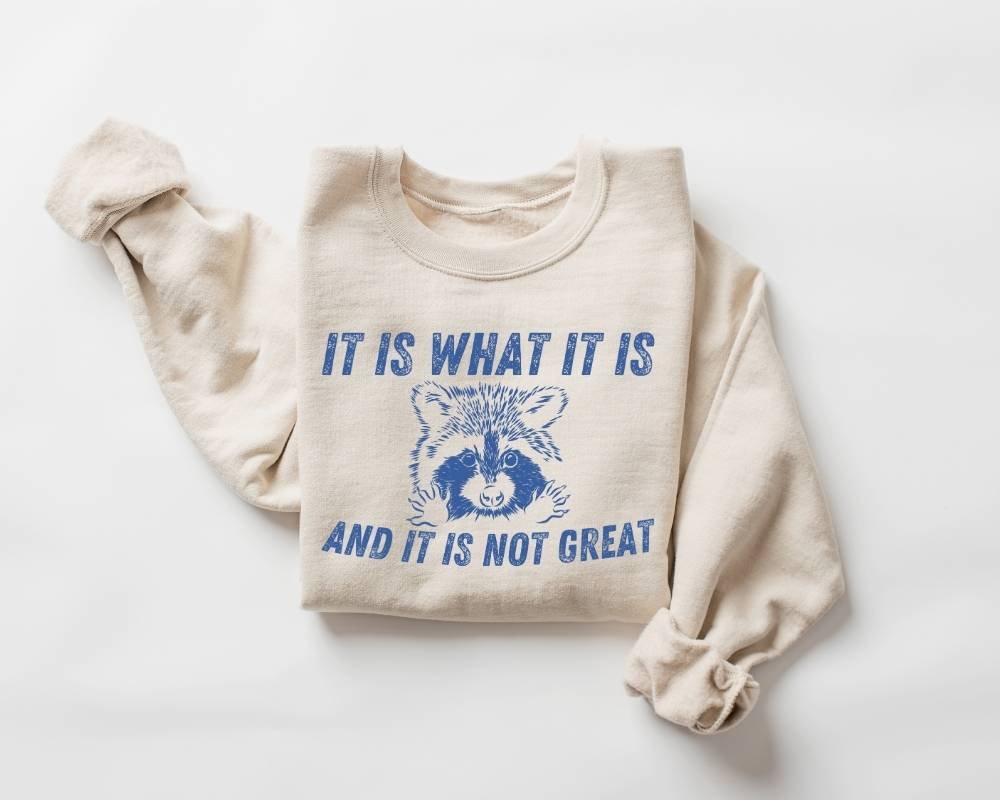 Beige (sand) sweatshirt with blue text and graphic on a white background