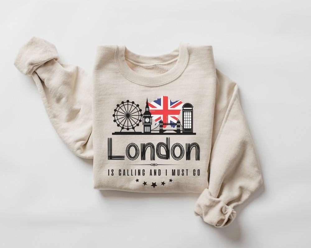 A beige (sand) sweatshirt featuring a London-themed design on a white background.