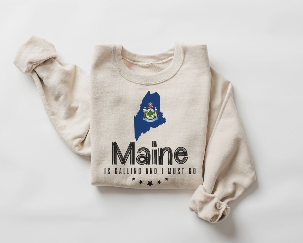 Beige (sand) sweatshirt with Maine state outline and text on a white background