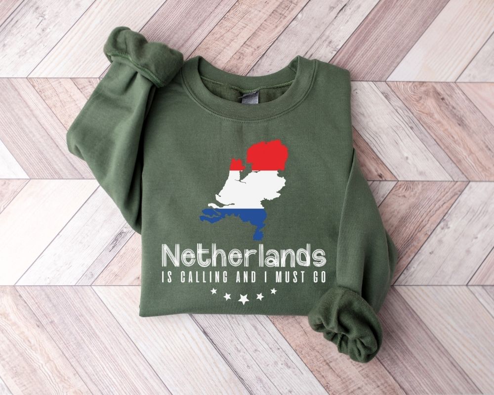 Military green sweatshirt with Netherlands design on a wooden floor