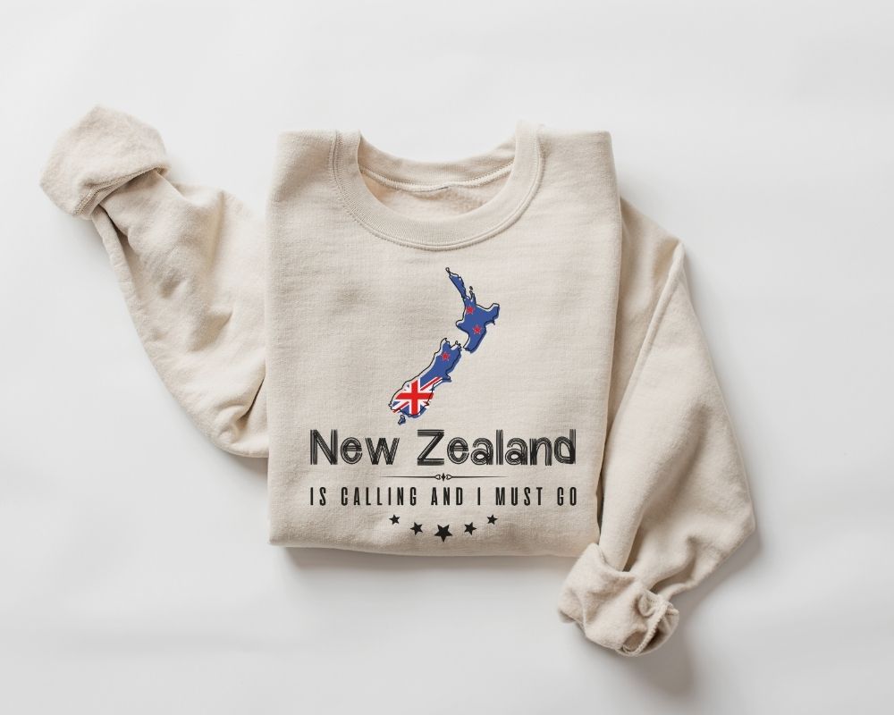 Beige (sand) sweatshirt with New Zealand design and text on a white background