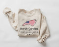 Beige (sand) sweatshirt with North Carolina design and text on a white background