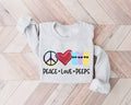 Gray (ash) sweatshirt with peace, love, and peeps design on a wooden floor