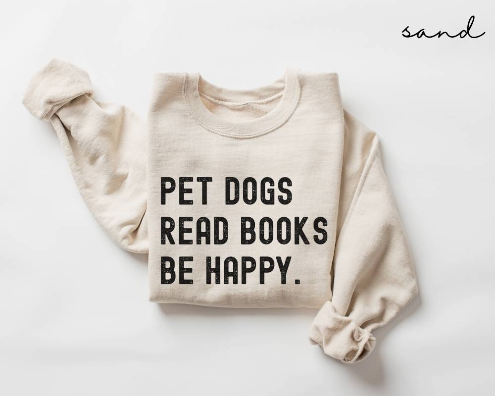 Beige (sand) sweatshirt with text 'PET DOGS READ BOOKS BE HAPPY' on a white background