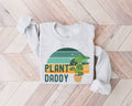 White (ash) sweatshirt with 'Plant Daddy' graphic on a wooden floor