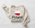 Beige (sand) sweatshirt featuring the Polish flag along with text on a white background.