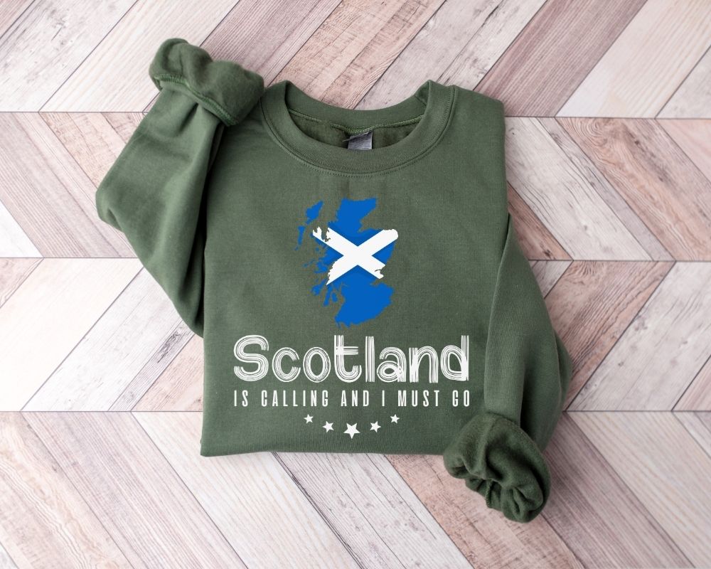Millitray green sweatshirt with Scottish design and text on a wooden floor