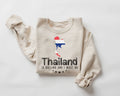 Beige (sand) sweatshirt with Thailand-themed design on a white background