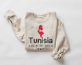 Beige (sand) sweatshirt with a red map of Tunisia and text on a white background