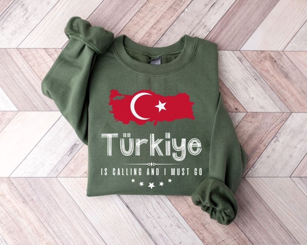 Military green sweatshirt with Turkish flag and text on a wooden floor