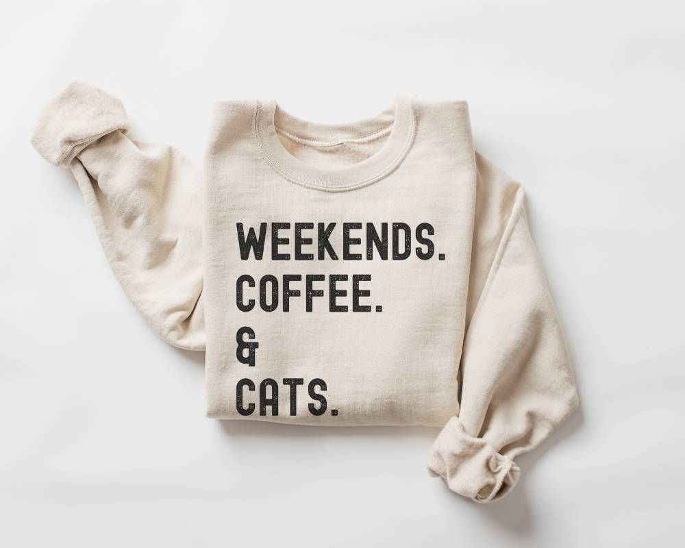 Beige (sand) sweatshirt with text 'Weekends. Coffee. & Cats.' on a white background